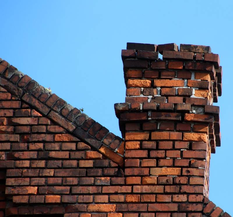 Damaged chimney on an Haltom City home showing cracks and missing mortar